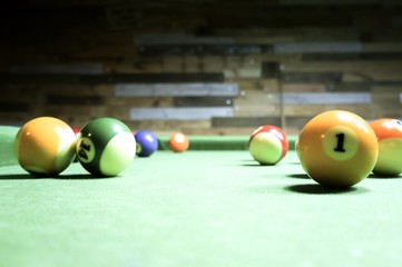 Billiards balls on a green board