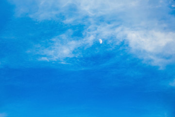 Blue sky with moon and white clouds in the evening_