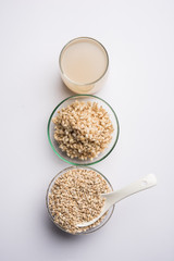 Barley water in glass with raw and cooked pearl barley wheat/seeds. selective focus