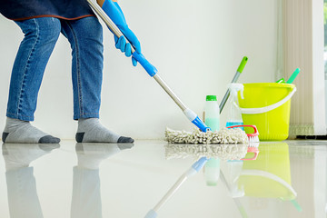 Cleaning Service concept. Cleaners employee removing dirt with equipment in office.