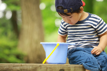 バケツの中を見る男の子
