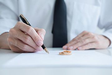 Judge gavel with Justice lawyers deciding, consultation on marriage divorce between married couple and signing divorce documents on table. Concepts of Law and Legal sevices.