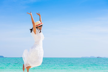 Happy woman enjoying beautiful sunset on the beach. Relaxing concept