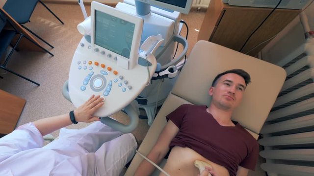 Ultrasound procedure carried out on a male patient by a doctor