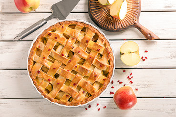 Composition with delicious apple pie on wooden background