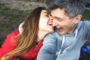 Obraz premium happy young couple making funny selfies