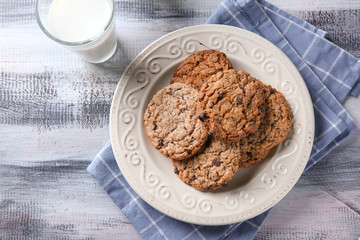 Plate with delicious oatmeal cookies on table