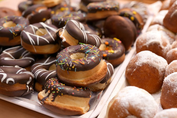 Fresh tasty donuts on display in bakery