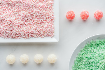 Plakat top view of green and pink sea salt and handmade soap on white