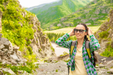 Happy smiling woman hiking in mountains enjoying outdoor activity. Space for text