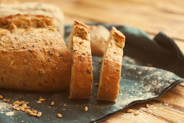 Sliced tasty bread on wooden table, closeup