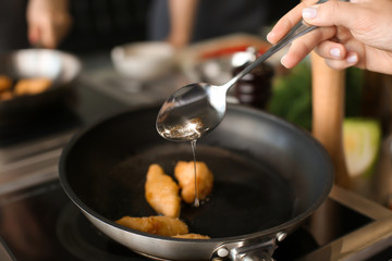 Female chef cooking in restaurant kitchen, closeup