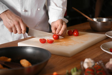 Male chef cutting vegetables during cooking classes