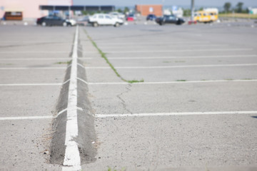 Parking is a large shopping center. There are not many cars.