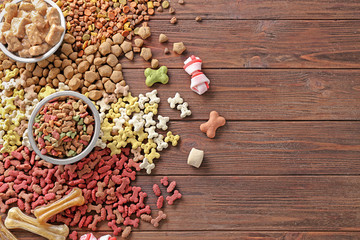 Different pet food on wooden background