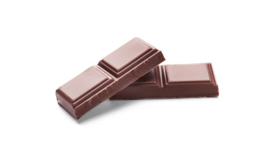 Delicious milk chocolate pieces on white background