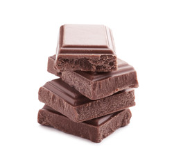 Delicious milk chocolate pieces on white background