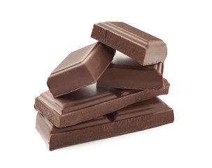 Delicious milk chocolate pieces on white background