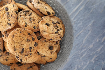 Plate with delicious chocolate chip cookies on table, top view