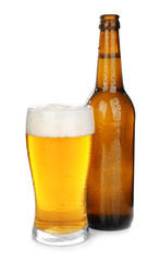 Glass and bottle of cold beer on white background