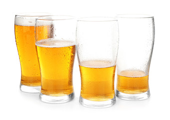 Glassware with cold beer on white background
