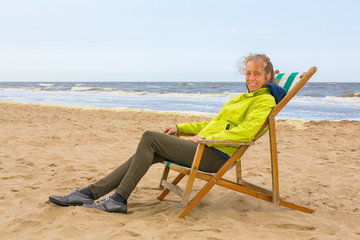 Dutch woman sits in beach chair by the sea