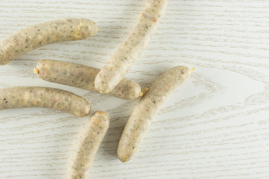 Lot of whole bavarian white sausage stack flatlay on grey wood