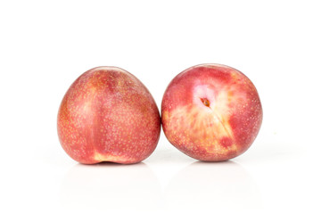 Group of two whole fresh pluot interspecific plums variety isolated on white