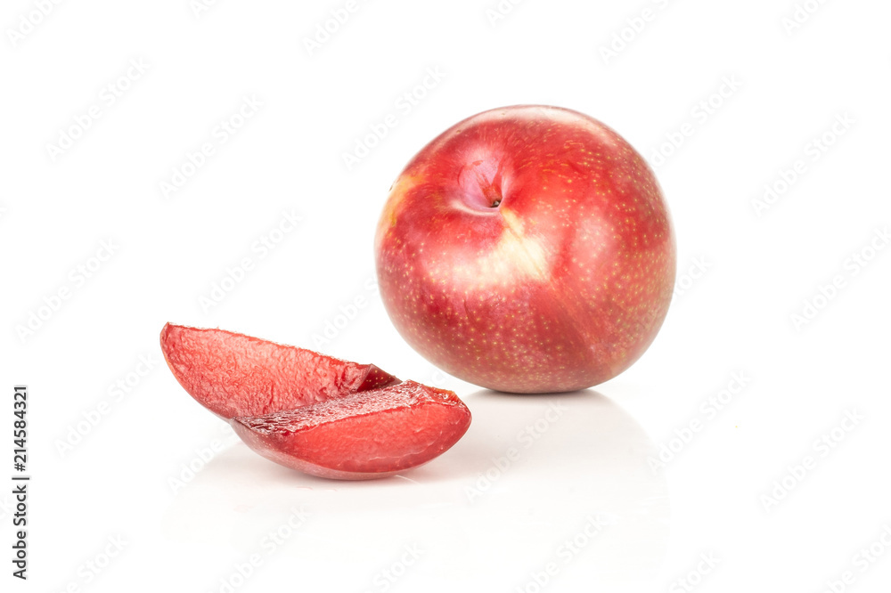 Wall mural Group of one whole two slices of fresh pluot interspecific plums variety isolated on white