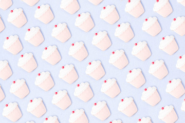 Sweets and desserts concept, donuts and cupcake cookies creative layout, simple pattern on trendy bright blue background, above