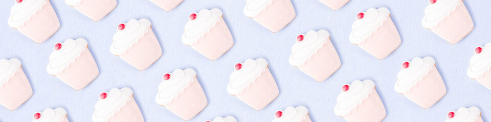 Sweets and desserts concept, donuts and cupcake cookies creative layout, simple pattern on trendy bright blue background, above  banner