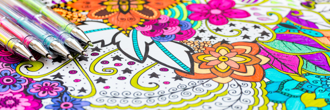 Adult coloring book, new stress relieving trend. Art therapy, mental health, creativity and mindfulness concept. Web banner, panoramic close up shot.