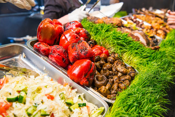 Outdoor Cuisine Culinary Buffet with healthy take away meal - grilled vegetables, salads, meat on the street food culinary market, festival, event. Selective focus. copy space.