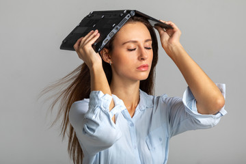 girl with laptop on head and eyes closed