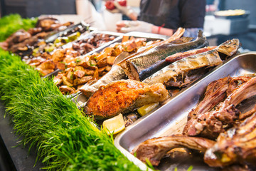 Outdoor Cuisine Culinary Buffet with healthy take away meal - grilled vegetables, fish and meat on the street food culinary market, festival, event. Selective focus. copy space.