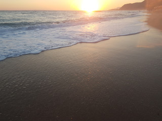 sunset sea waves foam splash  in summer Preveza Vrahos Greece