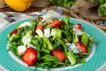 Salad with avocado and strawberry.