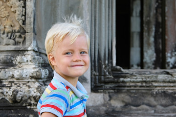 Cute little boy 4 years old blond hair sitting outdoor
