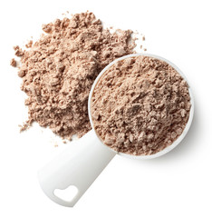 Measuring spoon and heap of chocolate protein powder