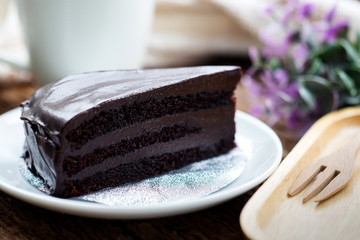 Chocolate cake on white plate.