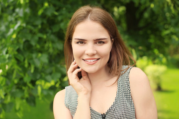 Portrait of beautiful young woman outdoors