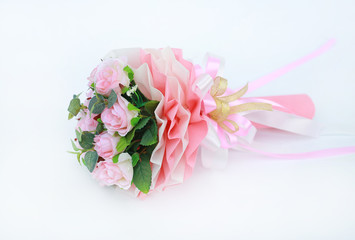 Artificial pink roses bouquet isolated on white background.