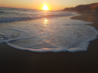 sunset sea waves foam splash  in summer Preveza Vrahos Greece