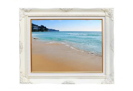 Antique white photo frame with Landscape view of Beautiful beach and tropical sea isolated on white background.