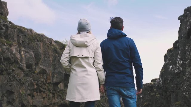 Young loving couple tourists in canyon of Iceland