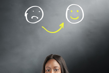 From sad to happy emoticons. Young woman choosing emotions