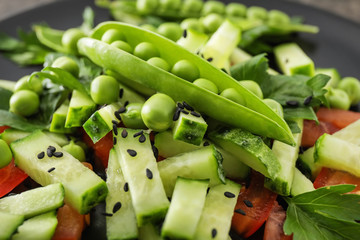 Vegetable salad with fresh green peas, closeup