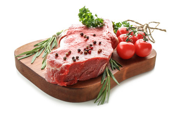 Wooden board with raw meat, vegetables and spices on white background