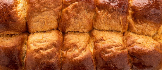 Fresh baked tasty sweet brioches, buns, loaves, french bread isolated on white background.
