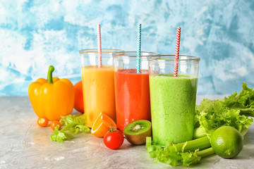 Glasses with fresh tasty smoothies and ingredients on table